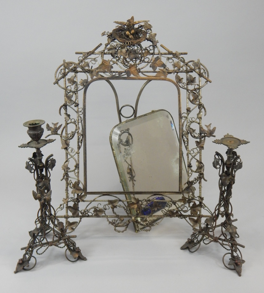 Appraisal: A Victorian silvered metal rectangular wall mirror the frame elaborately