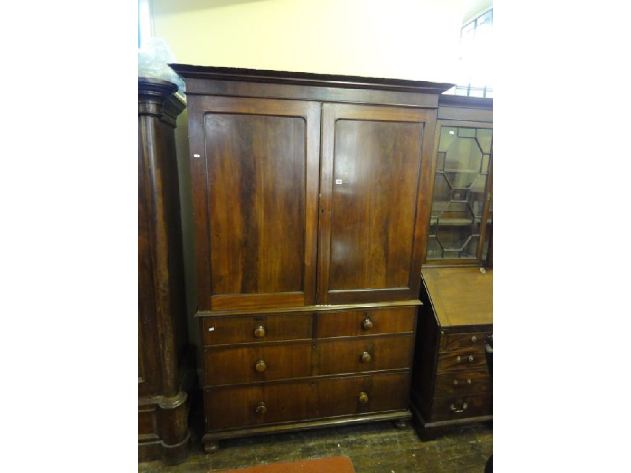 Appraisal: A mid Victorian mahogany linen press the base enclosed by