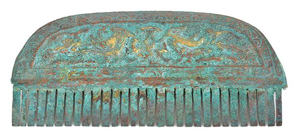 Appraisal: A BRONZE HAN COMB the curved surround embossed with bird