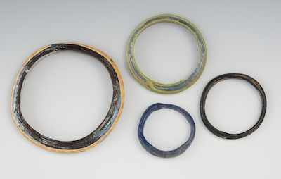 Appraisal: A Group of Roman Glass Style Bangle Bracelets Containing four