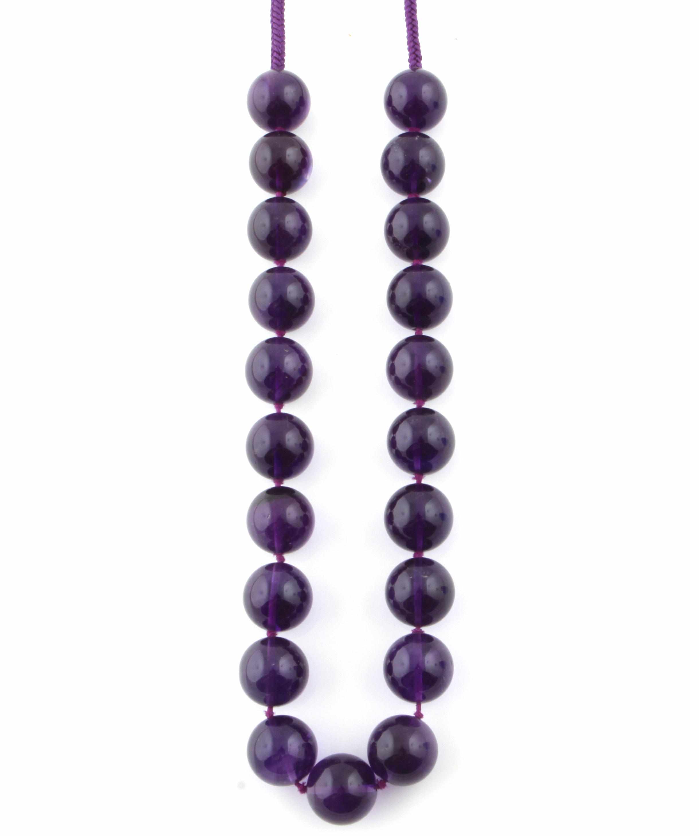 Appraisal: An amethyst bead and purple cord necklace