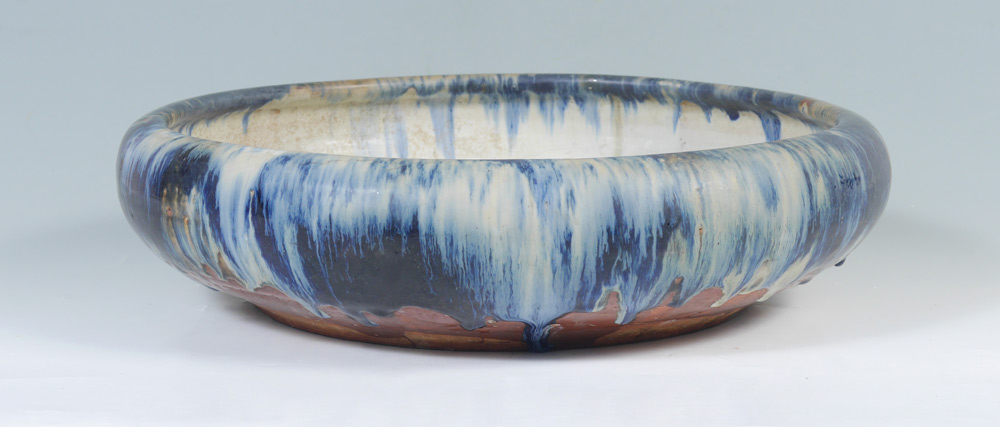 Appraisal: LARGE LOW JAPANESE POTTERY BOWL Blue drip glaze impressed Made