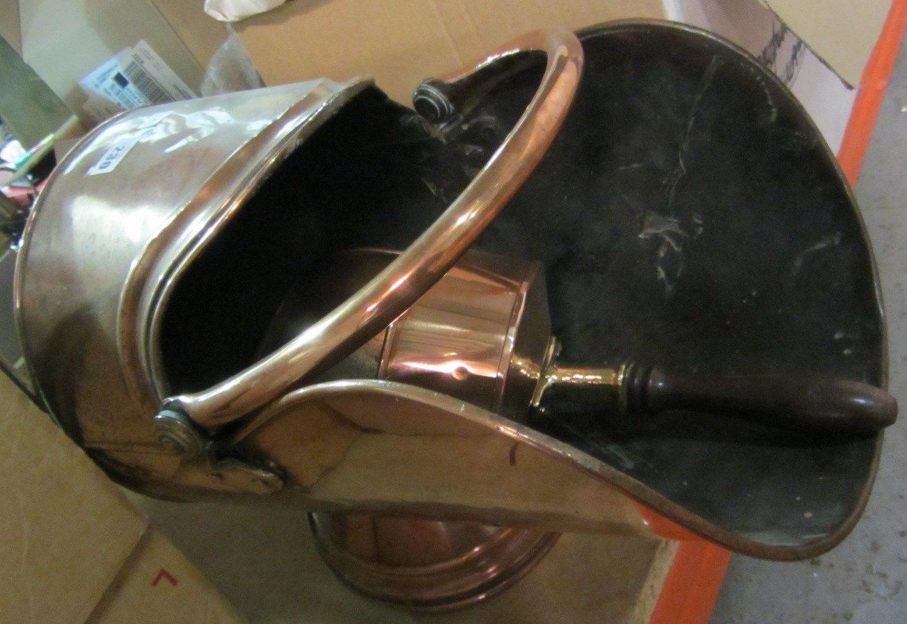 Appraisal: A copper helmet shaped coal scuttle with shovel