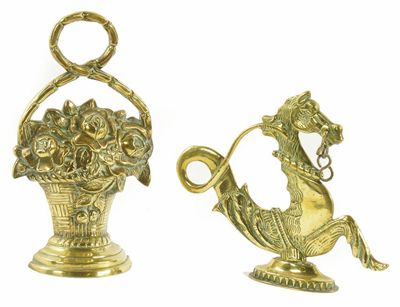 Appraisal: A brass doorstop modelled as a basket of flowers with