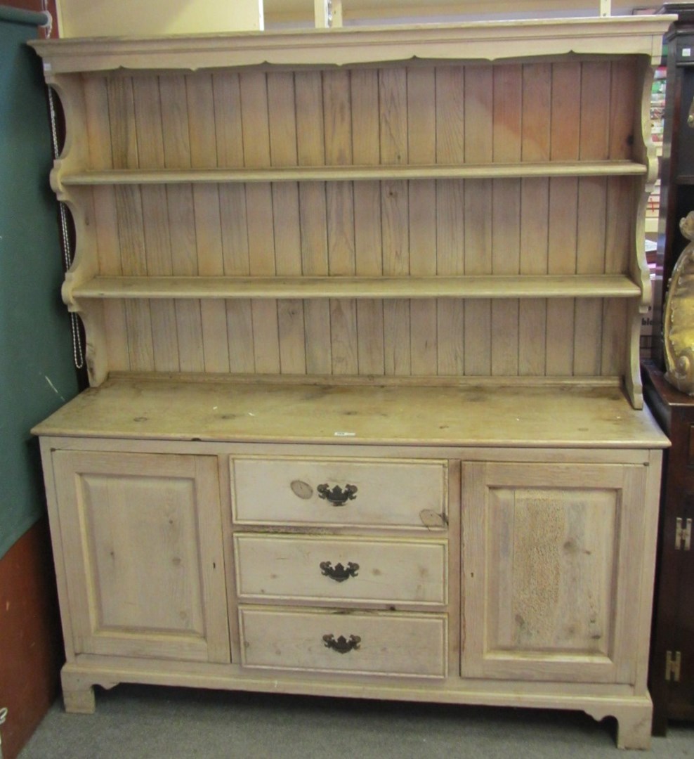 Appraisal: An th century style pine dresser the enclosed two tier