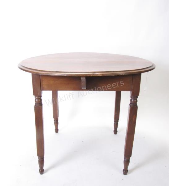 Appraisal: An antique pine table round top with turned legs h