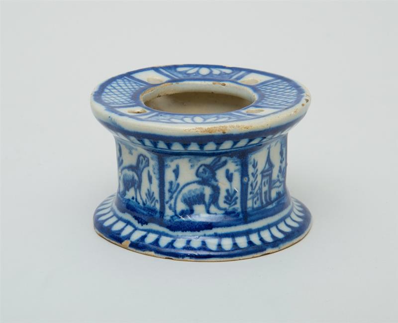 Appraisal: CONTINENTAL BLUE-GLAZED POTTERY CIRCULAR INKWELL The seven-sided bowl with cow