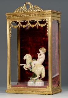 Appraisal: Pan Figurine w Small Brass Display Case Bavarian porcelain pan