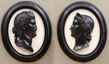 Appraisal: PAIR OF NEOCLASSICAL-STYLE RELIEF-MOLDED COMPOSITION MEDALLIONS Each oval with ebonized