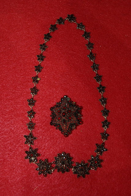 Appraisal: Late Victorian necklaceof floral form with garnet settings and matching