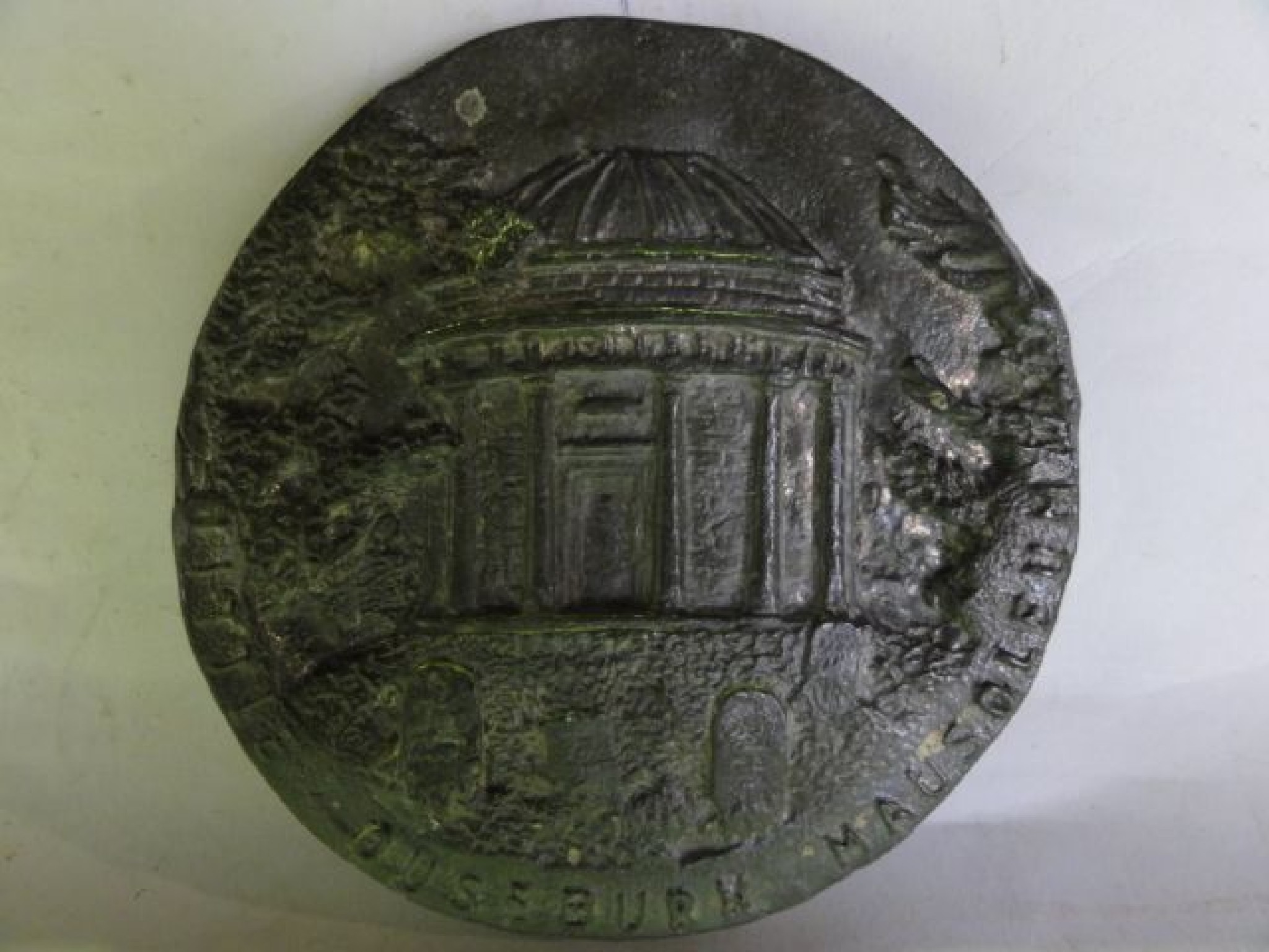 Appraisal: A lead panel of circular form with embossed detail -