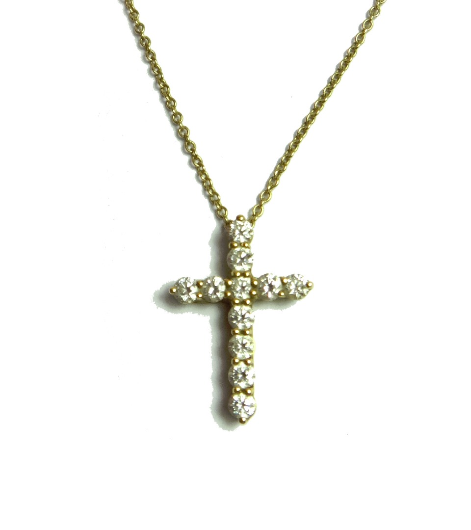 Appraisal: A Tiffany Co gold and diamond set pendant cross mounted