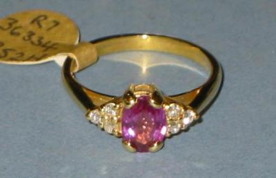 Appraisal: A PINK SAPPHIRE AND DIAMOND RING the oval cut sapphire