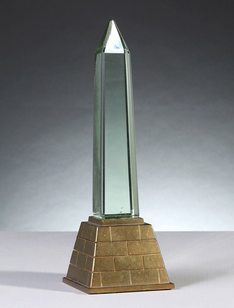 Appraisal: AN OBELISK MONUMENT INKWELL CIRCA The solid brass base cast