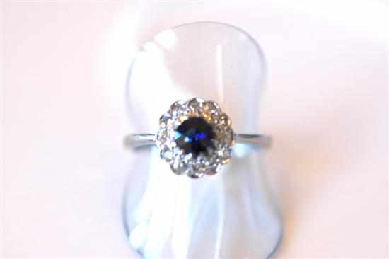 Appraisal: A SYNTHETIC SAPPHIRE AND DIAMOND CLUSTER RING IN CT WHITE