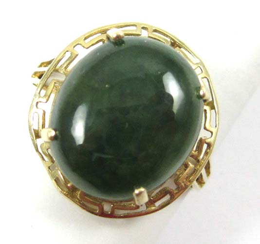 Appraisal: GREEN JADE AND FOURTEEN KARAT GOLD RING set with an