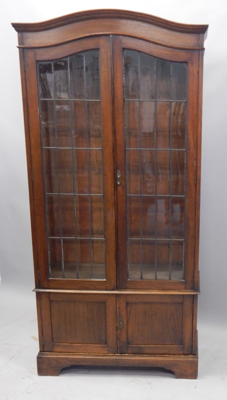 Appraisal: An early thC oak bookcase with two leaded glazed doors