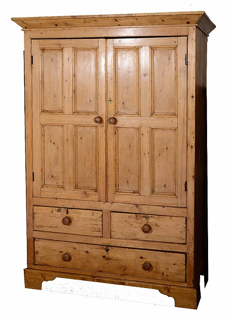 Appraisal: A Victorian pine cupboardwith two panelled doors over two short