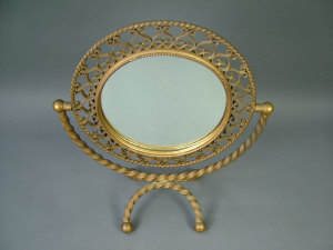 Appraisal: A Chaty Vallauris ornate gold enamelled metal dressing table mirror