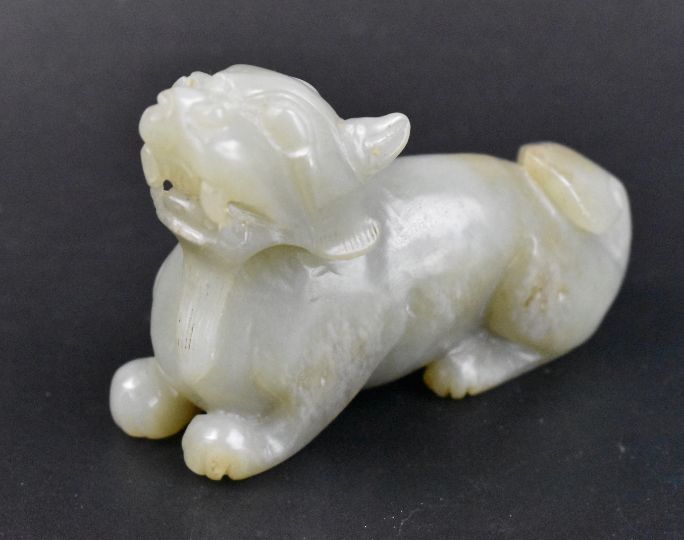 Appraisal: A Chinese celadon jade carving of a beast The beast