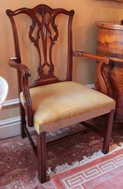 Appraisal: A SET OF FOUR CHIPPENDALE STYLE MAHOGANY CARVER ARMCHAIRS with