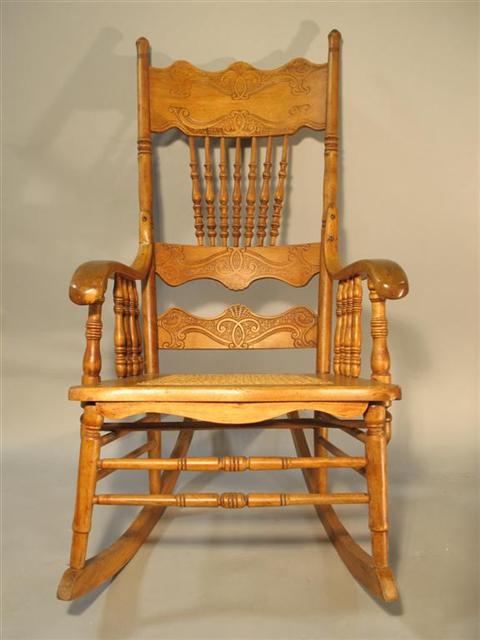 Appraisal: VICTORIAN STYLE ROCKING CHAIR The scalloped crest rail joined by