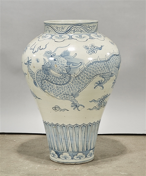 Appraisal: Tall Chinese blue and white porcelain vase with dragons chasing