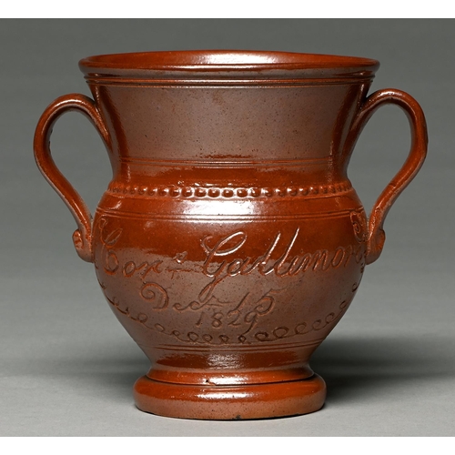 Appraisal: A Derbyshire saltglazed brown stoneware loving cup Chesterfield or Brampton