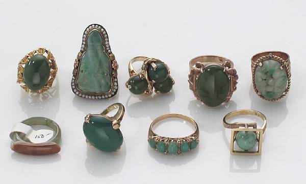 Appraisal: A collection of nine jade green stone and gold rings