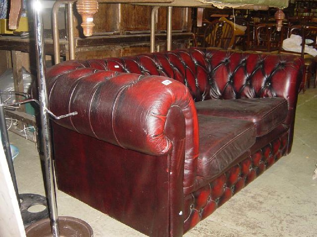 Appraisal: A contemporary two seat burgundy leather Chesterfield sofa