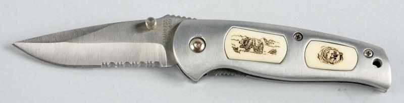 Appraisal: Stainless Steel Knife Description Ivory colored plates that have bear