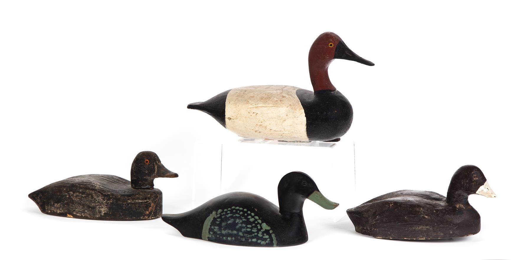 Appraisal: FOUR DUCK DECOYS American th century Black with glass eyes