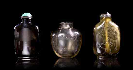 Appraisal: A Group of Three Smokey Quartz Snuff Bottles the first