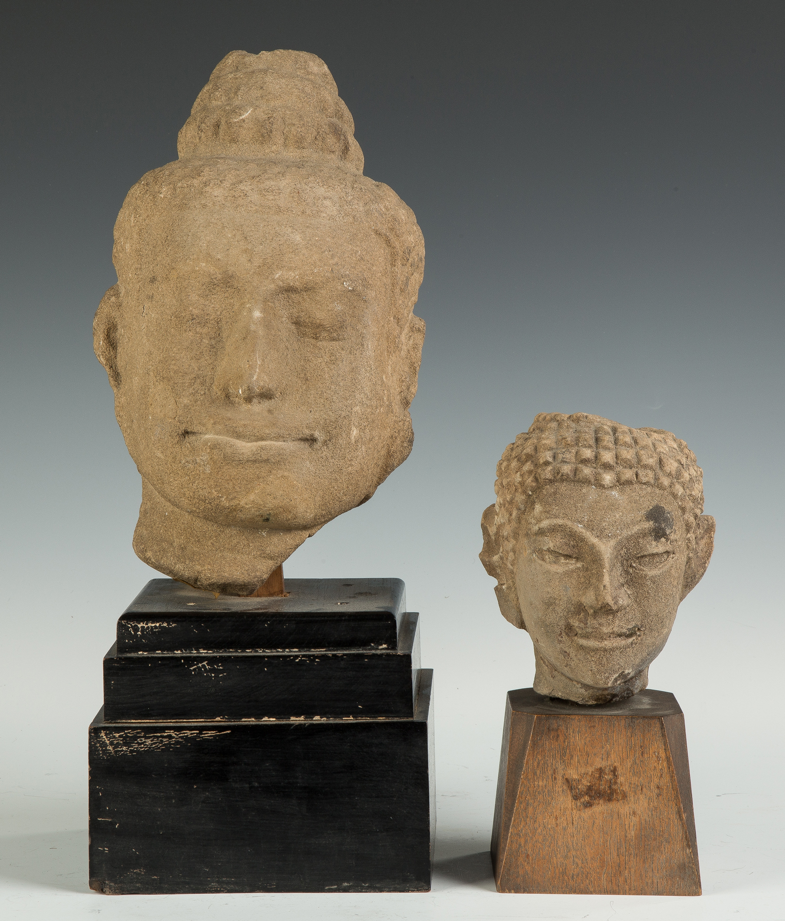 Appraisal: Two Early Sandstone Heads Early pre- Cambodian Sandstone Buddhist Head