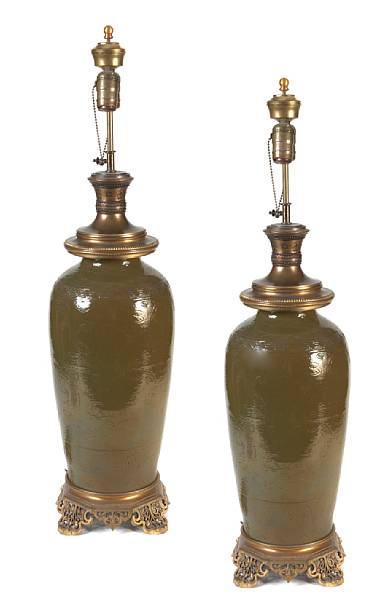 Appraisal: A pair of Chinese olive glazed oval pottery jars with