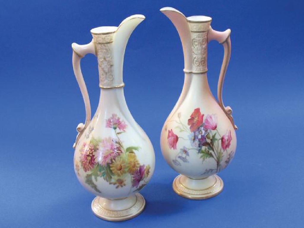 Appraisal: TWO ROYAL WORCESTER BLUSH IVORY EWERS each decorated with floral