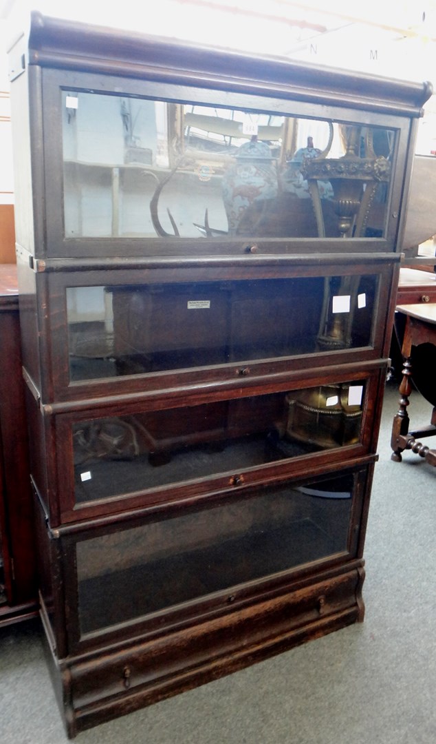 Appraisal: A Globe Wernicke four section bookcase with drawer base cm