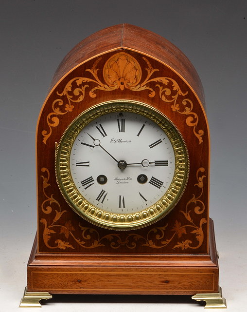 Appraisal: A MAHOGANY MANTEL CLOCK having a white enamel Roman dial