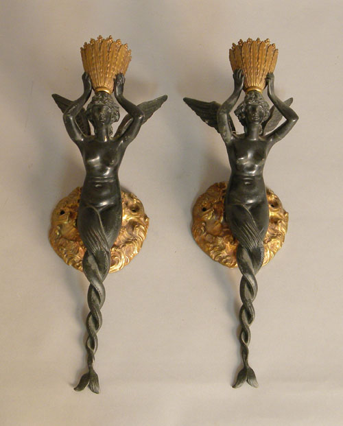 Appraisal: Pair of figural metal sconces in the form of winged