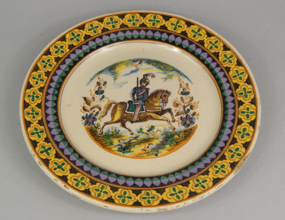 Appraisal: A Continental tin glazed charger decorated centrally with a soldier