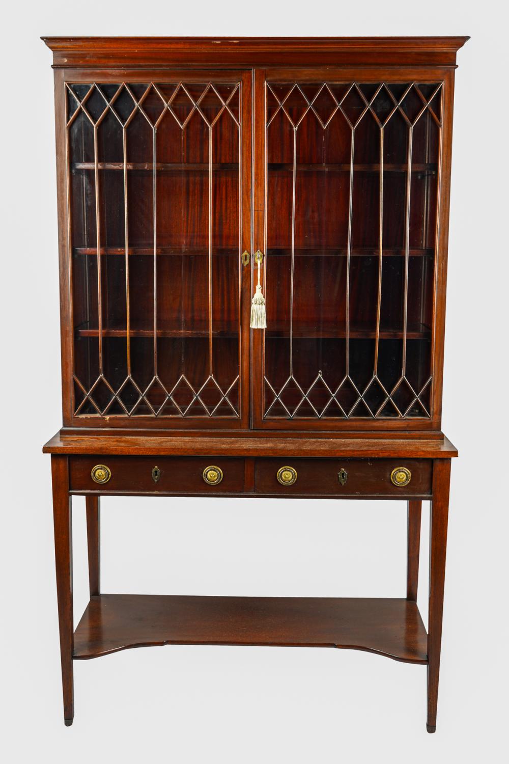 Appraisal: MAHOGANY TWO-PART CHINA CABINETthe glazed doors enclosing three shelves the