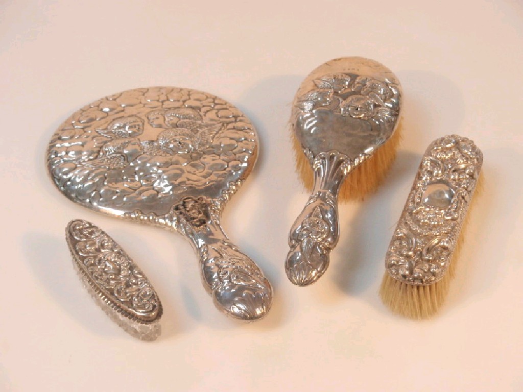 Appraisal: An early thC silver backed hair brush embossed with cherub