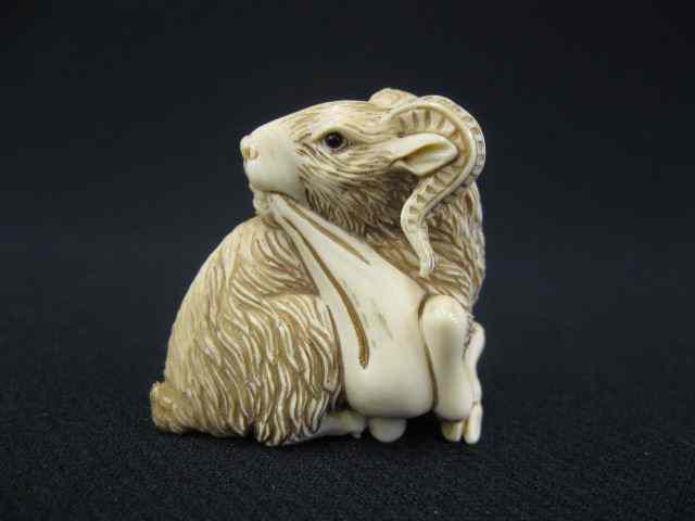 Appraisal: Carved Ivory Netsuke of a Seated Ram holding a treasue