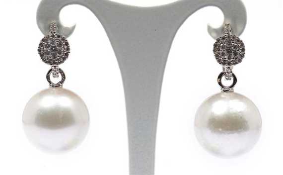 Appraisal: PEARL AND DIAMOND EAR STUD White gold and Decorative creoles