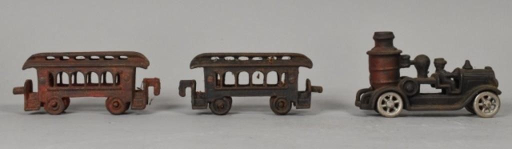 Appraisal: cast iron toys a fire pumper and train cars Rust