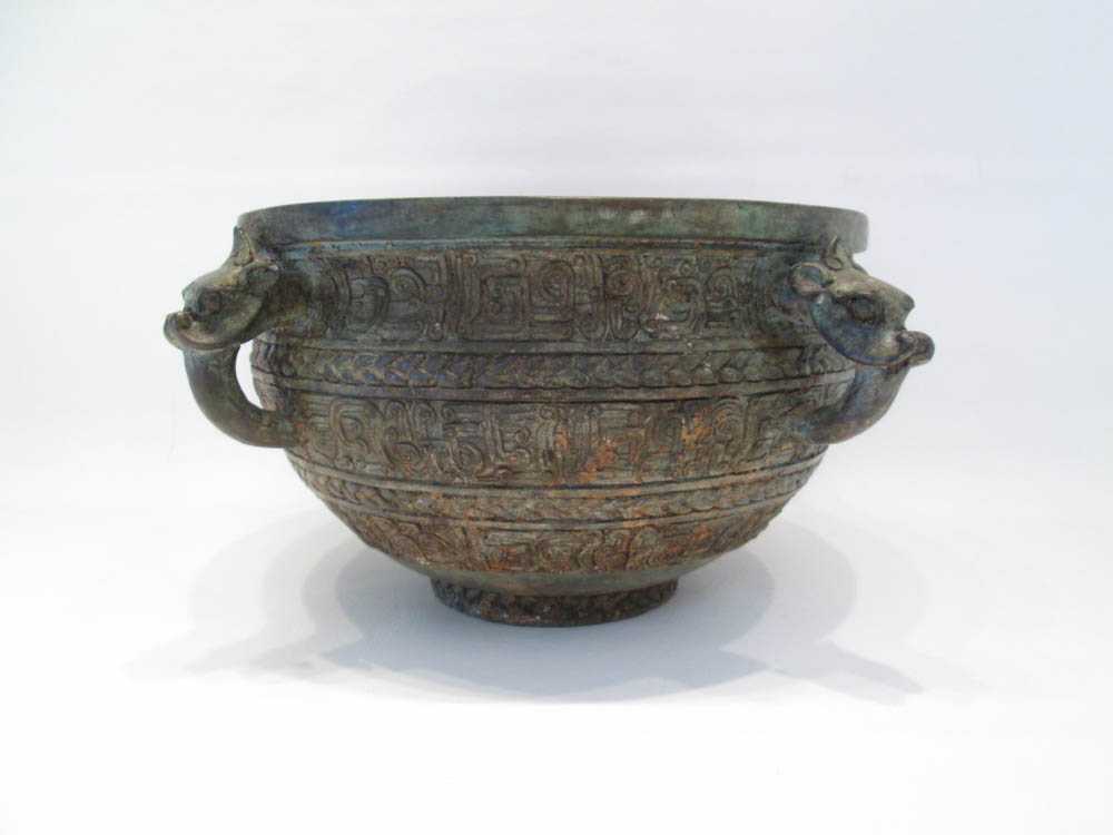 Appraisal: CHINESE BRONZE JARDINIERE with four mask handles and tapered having