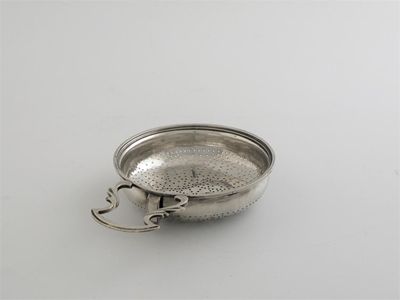 Appraisal: A George III lemon strainer with a plain tang openwork