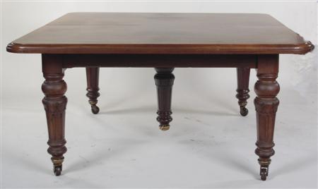 Appraisal: A Victorian mahogany extending dining table and leaf holder the