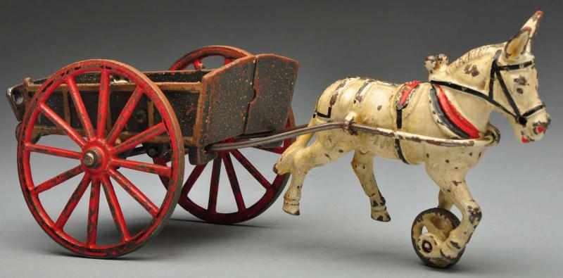 Appraisal: Cast Iron Wilkins Dumping Cart Donkey-Drawn Toy Description American Original