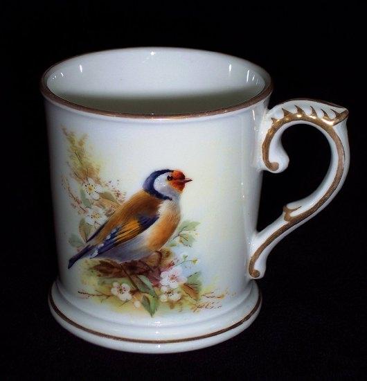 Appraisal: A Royal Worcester mug painted a chaffinch with C scroll